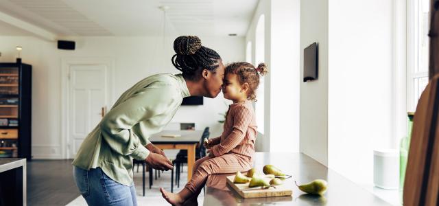 Single Mother and Her Little Girl Having a Snack at Home